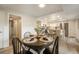 Open dining room with modern chairs and access to the kitchen and living spaces at 404 Raspberry Ln, Monument, CO 80132
