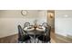 Cozy dining room with a round table, chandelier, and access to the kitchen at 404 Raspberry Ln, Monument, CO 80132