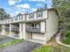View of townhome featuring attached garages and charming covered balconies on a sunny day at 404 Raspberry Ln, Monument, CO 80132