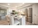 Well-lit kitchen featuring stainless steel appliances, granite countertops, and a convenient breakfast bar with comfortable seating at 404 Raspberry Ln, Monument, CO 80132