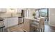 Bright kitchen featuring white cabinets, stainless steel appliances, granite counters, and a convenient island with seating at 404 Raspberry Ln, Monument, CO 80132