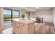 Kitchen island with seating overlooking a beautiful view from the sliding glass doors to the outdoor deck at 404 Raspberry Ln, Monument, CO 80132