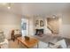 Bright living room featuring hardwood floors, a fireplace, and lots of natural light at 404 Raspberry Ln, Monument, CO 80132