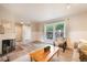 Inviting living room with fireplace and large window bringing in natural light at 404 Raspberry Ln, Monument, CO 80132