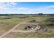 Expansive aerial view of a modern home on a large lot with a winding driveway at 5815 Peppy San Cir, Sedalia, CO 80135
