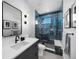 Modern bathroom with a walk-in shower featuring stylish tile, a vanity, and updated fixtures at 5815 Peppy San Cir, Sedalia, CO 80135