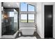 Modern bathroom featuring a glass shower, freestanding tub, and large windows with scenic views at 5815 Peppy San Cir, Sedalia, CO 80135