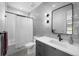 Modern bathroom with gray tiled accent wall, sleek vanity, and shower/tub combination at 5815 Peppy San Cir, Sedalia, CO 80135