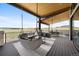 Relaxing covered deck with hanging chairs and stunning views, perfect for entertaining at 5815 Peppy San Cir, Sedalia, CO 80135