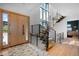 Stunning entryway with light wood floors and a staircase with modern metal railings at 5815 Peppy San Cir, Sedalia, CO 80135