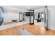 Bright home gym featuring a large mirror, wood flooring, and access to the game room at 5815 Peppy San Cir, Sedalia, CO 80135
