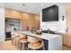 Bright kitchen with stainless steel appliances, oversized island with barstool seating, and custom cabinetry at 5815 Peppy San Cir, Sedalia, CO 80135