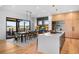 Open-concept kitchen and dining area with large windows and access to outdoor spaces at 5815 Peppy San Cir, Sedalia, CO 80135