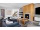 Bright living room featuring a modern fireplace, plush seating, and staircase to the upper level at 5815 Peppy San Cir, Sedalia, CO 80135