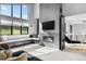 Cozy sitting area featuring a modern fireplace, bench, and large windows with scenic views at 5815 Peppy San Cir, Sedalia, CO 80135
