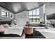 Bright main bedroom with vaulted ceiling, fireplace, sitting area, and scenic views at 5815 Peppy San Cir, Sedalia, CO 80135