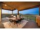 Covered outdoor dining area with mountain views, complete with a hanging swing chair at 5815 Peppy San Cir, Sedalia, CO 80135
