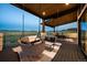 Covered patio with cushioned hanging swing and mountain views create the perfect outdoor retreat at 5815 Peppy San Cir, Sedalia, CO 80135