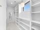 Bright walk-in closet with custom shelving and ample storage space at 5815 Peppy San Cir, Sedalia, CO 80135