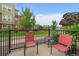 Relaxing balcony with seating and views of the green courtyard and landscaping at 12856 King St, Broomfield, CO 80020