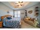 Comfortable bedroom featuring a tray ceiling, natural light, and a cozy seating area with a charming equestrian theme at 12856 King St, Broomfield, CO 80020