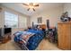 Cozy bedroom features a ceiling fan and natural light from the double window at 12856 King St, Broomfield, CO 80020