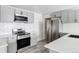 Modern kitchen with stainless steel appliances and gray cabinets at 14803 Olmsted Dr, Denver, CO 80239