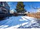 Expansive backyard covered in a layer of snow at 4443 E Bennington Ave, Castle Rock, CO 80104