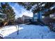 View of backyard with snow-covered ground and a deck at 4443 E Bennington Ave, Castle Rock, CO 80104