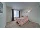 Guest bedroom with light pink walls and ample space at 4443 E Bennington Ave, Castle Rock, CO 80104