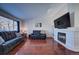 Bright living room features hardwood floors, fireplace, and comfortable seating at 4443 E Bennington Ave, Castle Rock, CO 80104