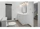 Bathroom featuring a tiled floor, glass-enclosed shower, vanity and sink at 6627 Eaton St, Arvada, CO 80003