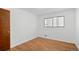 This bedroom offers hardwood floors and a large window for natural light at 6627 Eaton St, Arvada, CO 80003
