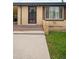 Charming brick home with an enclosed front entrance with storm door and a well maintained front yard at 6627 Eaton St, Arvada, CO 80003