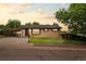 Charming brick home featuring a carport and well-maintained front yard with mature landscaping at 6627 Eaton St, Arvada, CO 80003