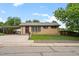 Charming brick home featuring a carport and well-maintained front yard with mature landscaping at 6627 Eaton St, Arvada, CO 80003