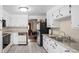 Bright kitchen with white cabinets, light countertops, and stainless steel appliances at 6627 Eaton St, Arvada, CO 80003