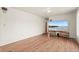 Bright living room with hardwood floors and modern television at 6627 Eaton St, Arvada, CO 80003