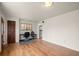 Inviting living room features hardwood floors, neutral walls, and adjacent kitchen at 6627 Eaton St, Arvada, CO 80003