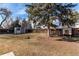 Spacious backyard featuring mature trees, shed, chicken coop, fenced yard and plenty of room to roam at 6111 W Maplewood Pl, Littleton, CO 80123