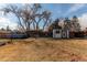 Large backyard featuring a chicken coop, shed, above-ground pool and mature trees, offering ample space for recreation at 6111 W Maplewood Pl, Littleton, CO 80123