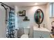 Beautiful bathroom featuring modern fixtures, floating shelves, and unique design at 6111 W Maplewood Pl, Littleton, CO 80123