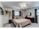 Cozy bedroom featuring large bed, bedside tables, and relaxing natural light at 6111 W Maplewood Pl, Littleton, CO 80123