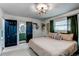 Bedroom with modern style doors leading to ensuite bathroom at 6111 W Maplewood Pl, Littleton, CO 80123