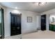 Bedroom featuring a barn door style closet, leading to modern bathroom at 6111 W Maplewood Pl, Littleton, CO 80123