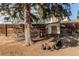 Backyard coop with chickens shows a rural style in an urban setting and room to roam under mature shade tree at 6111 W Maplewood Pl, Littleton, CO 80123