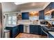 Gourmet kitchen with stainless appliances, quartz countertops, subway tile backsplash, and modern fixtures at 6111 W Maplewood Pl, Littleton, CO 80123