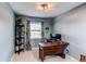 Home office space featuring a wooden desk, shelving, and a bright window at 6111 W Maplewood Pl, Littleton, CO 80123