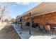 Brick house with a covered patio area for outdoor dining and relaxation at 6111 W Maplewood Pl, Littleton, CO 80123