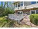 Backyard featuring a patio, lush greenery, and a charming stone and siding house exterior at 6803 W Yale Ave, Lakewood, CO 80227
